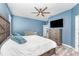 Bedroom with blue walls, ceiling fan, wood floors and a full size bed at 140 Trinity Ridge Cir, Davenport, FL 33897