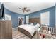 Bedroom with blue walls, ceiling fan, wood floors, walk in closet and a full size bed at 140 Trinity Ridge Cir, Davenport, FL 33897