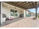 Covered patio featuring brick pavers, a ceiling fan, sliding glass doors, and outdoor furniture at 140 Trinity Ridge Cir, Davenport, FL 33897