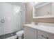 Modern bathroom featuring a glass-enclosed shower with mosaic tile and a vanity with a white countertop at 25601 Hutcheson Ln, Sorrento, FL 32776