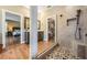Bright bathroom featuring a walk-in shower, vanity with mirror, and convenient access to the main bedroom at 25601 Hutcheson Ln, Sorrento, FL 32776