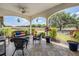 Relaxing covered patio features detailed tile flooring, comfortable seating, and a scenic view of the horse property at 25601 Hutcheson Ln, Sorrento, FL 32776