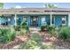 Charming home with a welcoming front porch, lush landscaping, and a beautifully maintained exterior at 25601 Hutcheson Ln, Sorrento, FL 32776