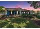Exterior view of a home with covered porches at dusk at 25601 Hutcheson Ln, Sorrento, FL 32776