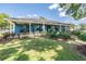 Charming exterior with a sprawling lawn and covered porches at 25601 Hutcheson Ln, Sorrento, FL 32776