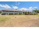 Exterior view of the property showcasing the facade, lawn, and blue sky at 25601 Hutcheson Ln, Sorrento, FL 32776