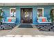 Inviting front porch with cozy porch swings, colorful pillows, and a stylish entrance at 25601 Hutcheson Ln, Sorrento, FL 32776
