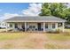 Charming ranch-style home with inviting front porch and well-maintained landscaping at 25601 Hutcheson Ln, Sorrento, FL 32776