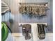 Well-organized equestrian equipment, including bits, blankets, and belts, neatly arranged on a wall-mounted rack at 25601 Hutcheson Ln, Sorrento, FL 32776