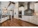 Bright kitchen features stainless appliances, sleek tile backsplash, modern cabinets, and wood beam architectural design at 25601 Hutcheson Ln, Sorrento, FL 32776