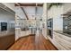 Spacious kitchen featuring stainless steel appliances, farmhouse sink, and a beamed ceiling at 25601 Hutcheson Ln, Sorrento, FL 32776