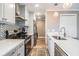 Modern kitchen with stainless steel appliances, white cabinets, and herringbone backsplash at 25601 Hutcheson Ln, Sorrento, FL 32776