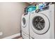 Bright laundry area with Samsung washer and dryer, plus storage and accessories at 25601 Hutcheson Ln, Sorrento, FL 32776