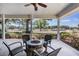 Relaxing outdoor seating area with comfortable chairs, a fire pit, and a serene view of the surrounding landscape at 25601 Hutcheson Ln, Sorrento, FL 32776
