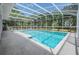 Sparkling in-ground swimming pool with a screened enclosure, providing a refreshing escape in a private backyard setting at 25601 Hutcheson Ln, Sorrento, FL 32776