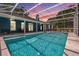Backyard pool with a large, screened-in enclosure and covered patios at 25601 Hutcheson Ln, Sorrento, FL 32776