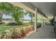 Inviting porch view of the beautiful, expansive property with lush landscaping and plenty of room to roam at 25601 Hutcheson Ln, Sorrento, FL 32776