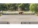 Equestrian arena showcasing a horse and rider, with a backdrop of tall trees for privacy and a serene riding experience at 25601 Hutcheson Ln, Sorrento, FL 32776