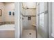 Bathroom shower with decorative tile detail, a shower bench and glass door at 25601 Hutcheson Ln, Sorrento, FL 32776