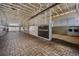 Horse stables aisle with brick floors, white walls and stalls, and metal doors at 25601 Hutcheson Ln, Sorrento, FL 32776