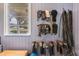 Organized tack room featuring riding equipment and a bright window showcasing the well-maintained equestrian space at 25601 Hutcheson Ln, Sorrento, FL 32776