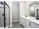 Modern bathroom featuring double vanity, quartz countertops, and a walk-in shower at 3319 Chinotto Dr, Lake Alfred, FL 33850