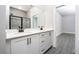 Modern bathroom with double vanity, quartz countertops, and glass-enclosed shower at 3319 Chinotto Dr, Lake Alfred, FL 33850