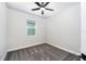 This cozy bedroom features soft gray carpet, natural light from the window, and a ceiling fan at 3319 Chinotto Dr, Lake Alfred, FL 33850