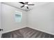 This cozy bedroom features soft gray carpet, natural light from the window, and a ceiling fan at 3319 Chinotto Dr, Lake Alfred, FL 33850