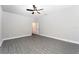 Large bedroom with gray wood floors, ceiling fan, and neutral walls at 3319 Chinotto Dr, Lake Alfred, FL 33850