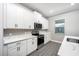 Bright kitchen featuring white cabinets, quartz countertops, and stainless steel appliances at 3319 Chinotto Dr, Lake Alfred, FL 33850