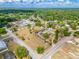 Aerial perspective of a residential neighborhood featuring diverse housing and abundant green spaces under a cloudy sky at 4145 Willis Rd, Mulberry, FL 33860