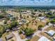 Expansive aerial view of a community with diverse homes and lush greenery under a partly cloudy sky at 4145 Willis Rd, Mulberry, FL 33860