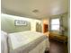 Bedroom with wood floors, soft green walls, and a view into the walk in closet, creating a welcoming space at 4145 Willis Rd, Mulberry, FL 33860
