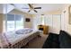 Cozy bedroom features a ceiling fan, sliding glass door, and functional desk area at 4145 Willis Rd, Mulberry, FL 33860
