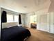 Simple bedroom provides a comfortable retreat with a vanity, natural light and carpeted floor at 4145 Willis Rd, Mulberry, FL 33860