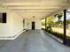 Open carport provides shelter for vehicles with direct access to the home at 4145 Willis Rd, Mulberry, FL 33860