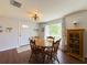 Cozy dining area with round table, wood floors, and natural light from the nearby window at 4145 Willis Rd, Mulberry, FL 33860