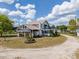 Charming farmhouse with front porch, upper deck, well-manicured lawn, and circular drive at 4145 Willis Rd, Mulberry, FL 33860
