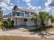 Rear view of the home with an elevated deck, a covered patio, and lush landscaping at 4145 Willis Rd, Mulberry, FL 33860