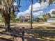 Charming two-story home with front porch, blue balcony, expansive lawn and fenced perimeter at 4145 Willis Rd, Mulberry, FL 33860