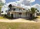 Back of the home with an upstairs deck, a covered patio, and a palm tree at 4145 Willis Rd, Mulberry, FL 33860