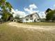 Exterior view of the home showing the extensive lot, the driveway, and the outbuilding at 4145 Willis Rd, Mulberry, FL 33860