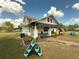 Inviting home featuring a cozy front porch with seating area and well-maintained landscaping at 4145 Willis Rd, Mulberry, FL 33860