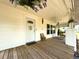 Welcoming front porch with a swing, a wooden floor, and a charming welcome sign on the door at 4145 Willis Rd, Mulberry, FL 33860