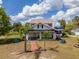 Charming two-story home with a welcoming front porch and a brick pathway leading to the entrance at 4145 Willis Rd, Mulberry, FL 33860