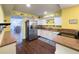 Well-lit kitchen showcasing a stainless steel refrigerator and a view into the dining area at 4145 Willis Rd, Mulberry, FL 33860