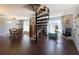 Bright open-concept living area with a unique spiral staircase and dining area that adds architectural interest at 4145 Willis Rd, Mulberry, FL 33860