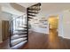 Open living space featuring a spiral staircase and decorative wall accents, leading into the kitchen area at 4145 Willis Rd, Mulberry, FL 33860