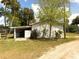 Exterior view of white outbuilding with attached carport at 4145 Willis Rd, Mulberry, FL 33860